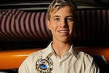 Surf lifesaver Matt Barclay holding a trophy.