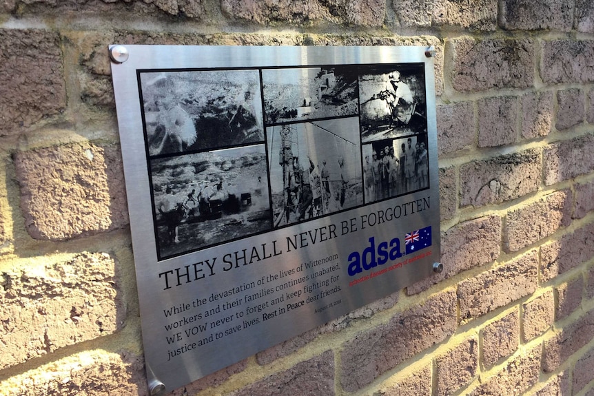 A plaque on a wall depicting mining scenes in Wittenoom.