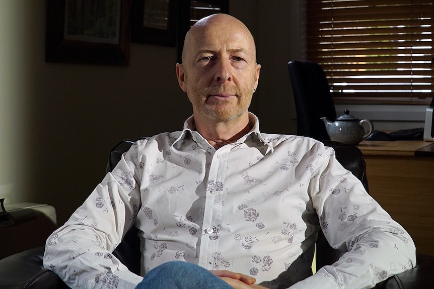 A man sitting in a home office.