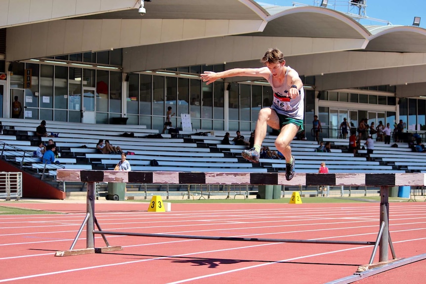 Timon Sideris jumps a hurdle