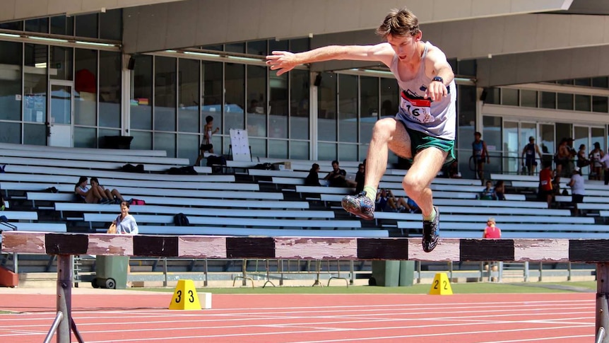 Timon Sideris jumps a hurdle