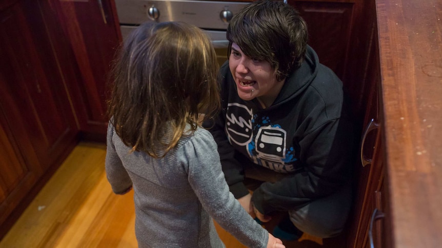 Erin bends down to talk to her daughter, Jayde.