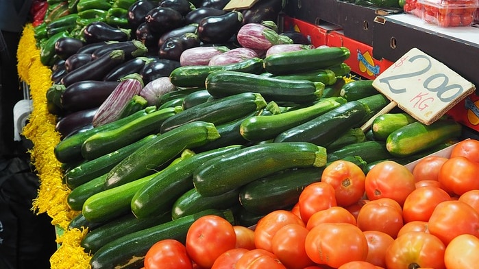 Photo of various vegtables at a stall at a market