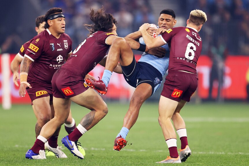 Daniel Tupou is forced back in the tackle