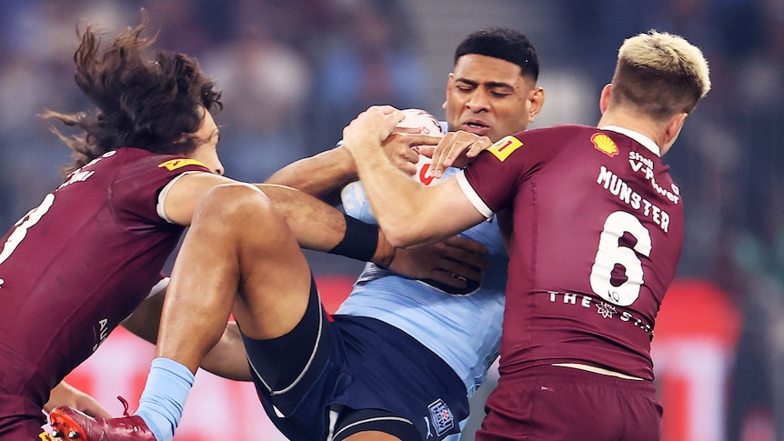 Daniel Tupou is forced back in the tackle