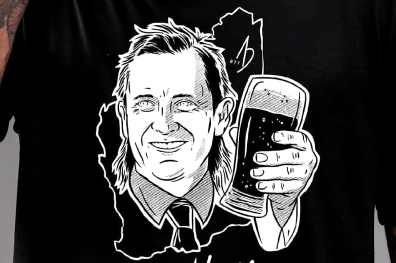 WA Premier Mark McGowan pictured on a t-shirt holding up a beer and wearing a mullet.