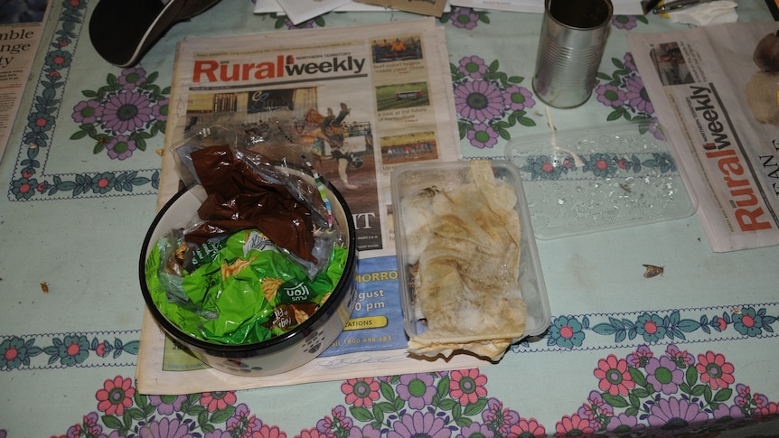 A bowl full of plastic bags and a takeaway container with dim sims on a copy of Rural Weekly.