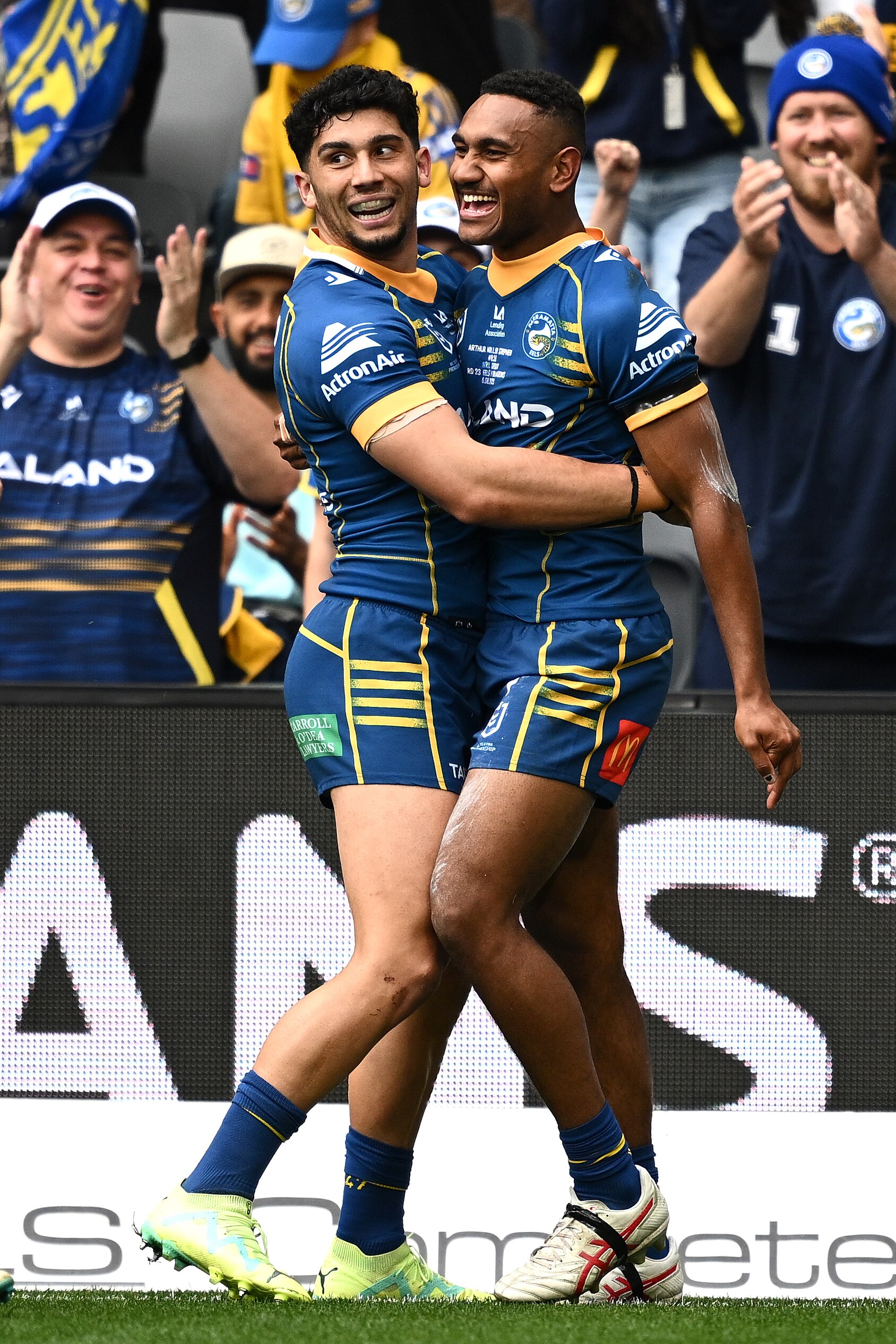 Two Parramatta Eels NRL players embrace as they celebrate a try.