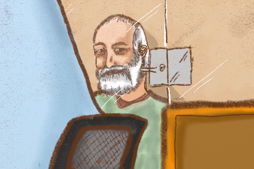 man with white beard in court box