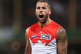 Lance Franklin clenches both fists and yells in celebration