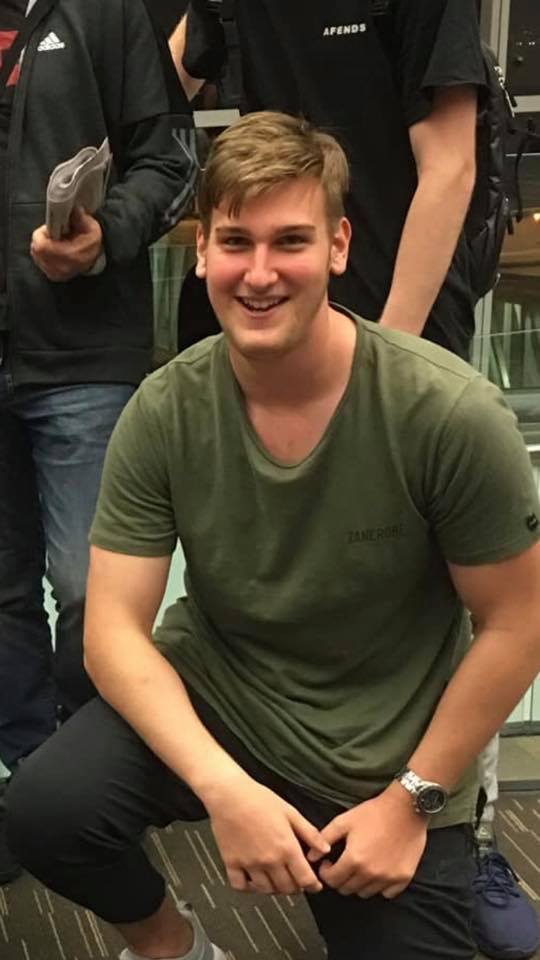 A young man with light brown hair smiling at the camera.