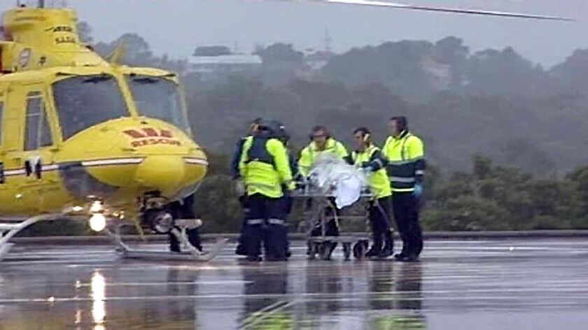 An air ambulance crew takes the injured man to Newcastle's John Hunter Hospital.