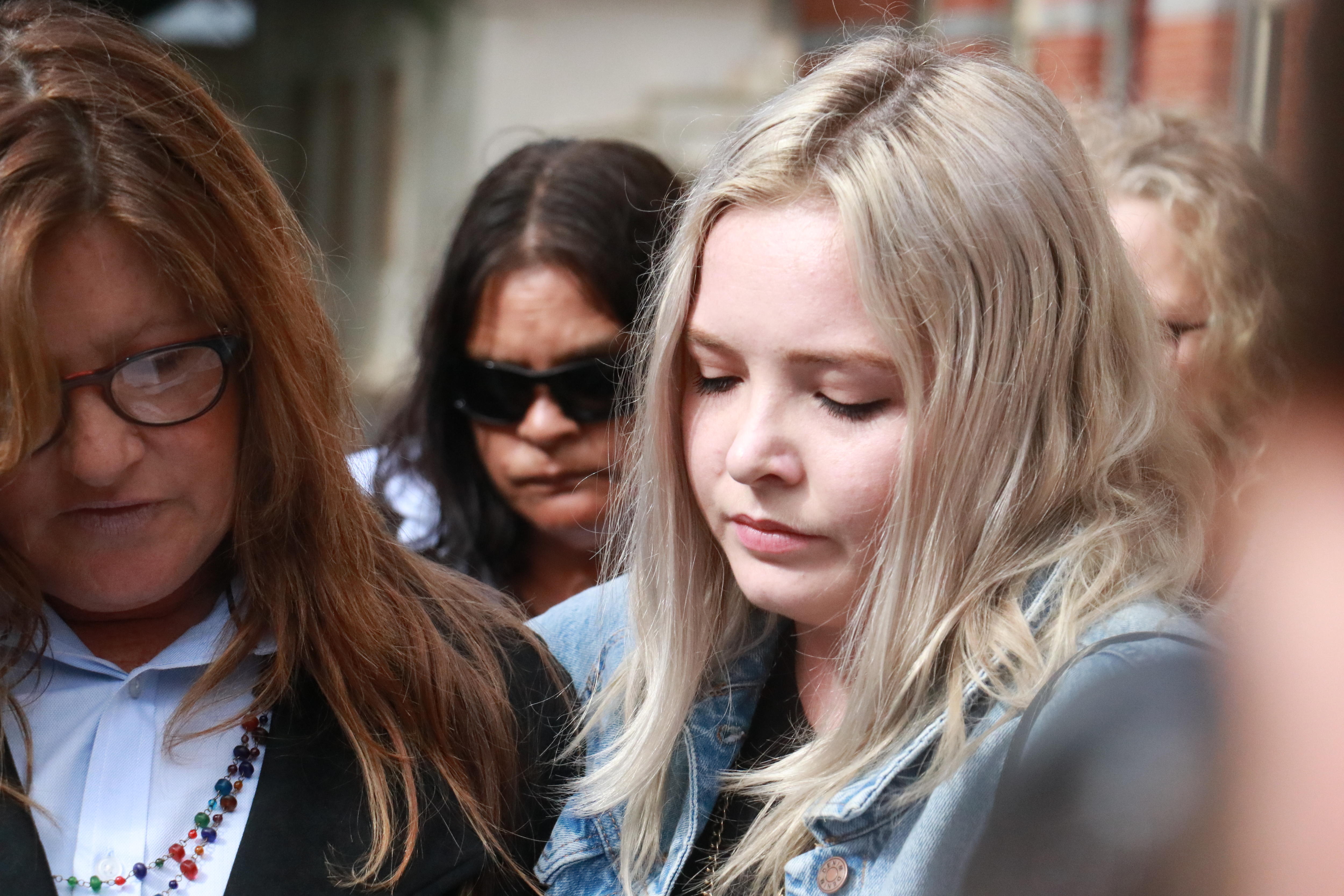 Taylor Brown stands beside Cheryl Francis reading a statement