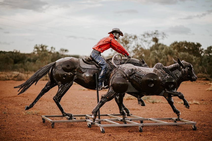 two metal sculptures of a musterer rounding up a bullock in outback Queensland