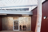 Children peer into a modern new building