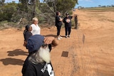 People looking at a field near a proposed nuclear waste dump in South Australia.
