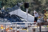 Rescue workers search rubble after a bridge collapsed at Florida International University