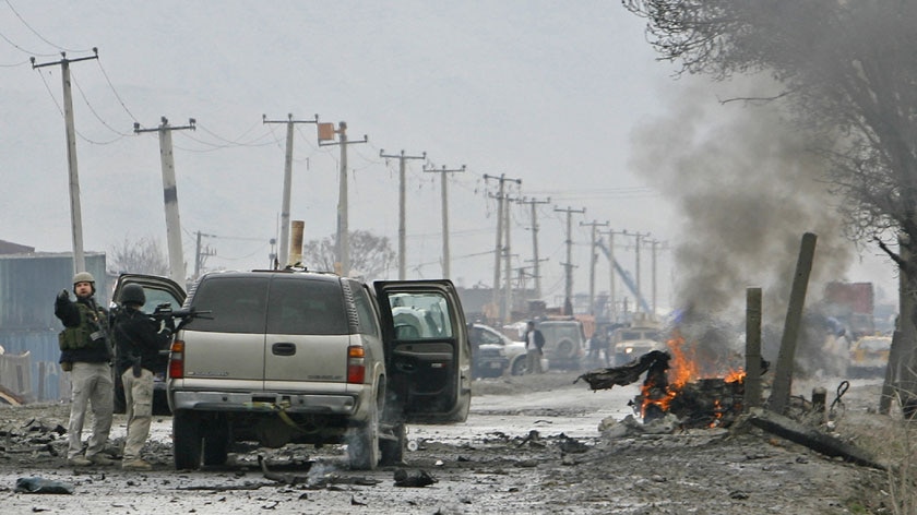 Foreign military personnel secure a suicide blast site in Kabul. (Reuters: Ahmad Masood)
