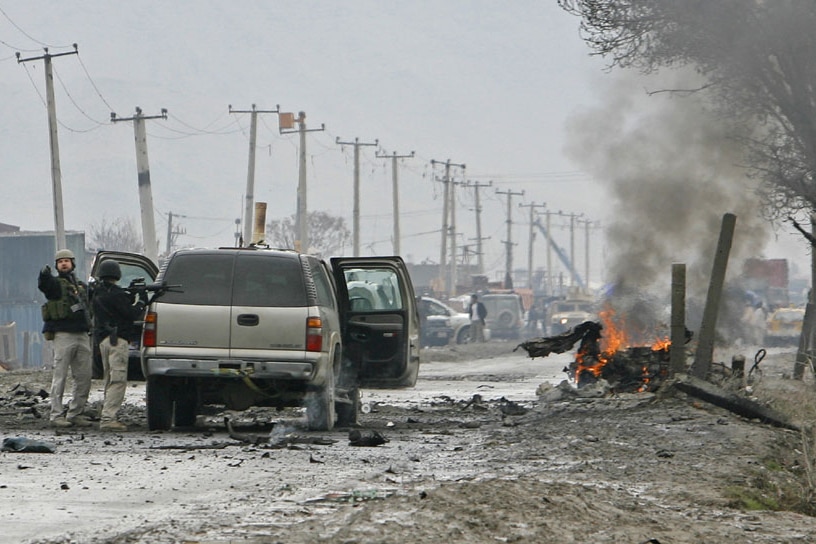 Foreign military personnel secure a suicide blast site in Kabul. (Reuters: Ahmad Masood)