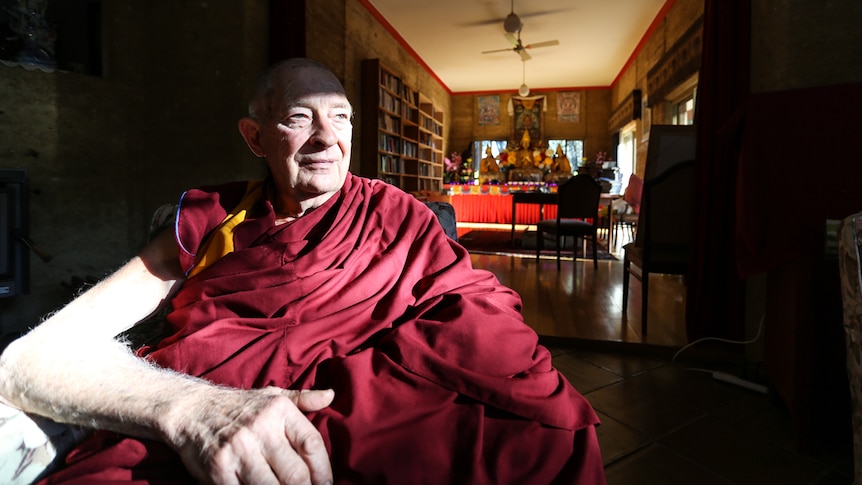 Venerable Thubten Gyatso sitting in an arm chair in the monastery near Bendigo.