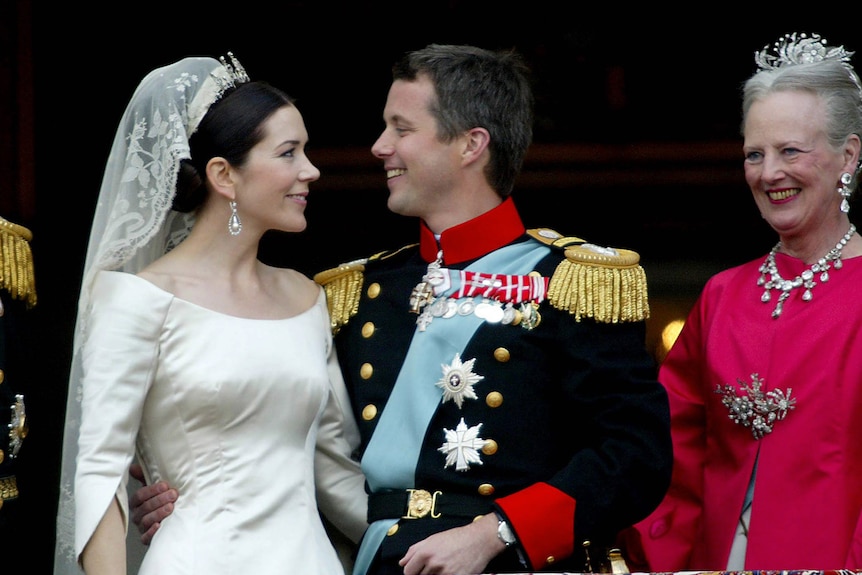 Prince Frederik and Princess Mary look lovingly into each other's eyes on their wedding day as Queen Margrethe looks on.