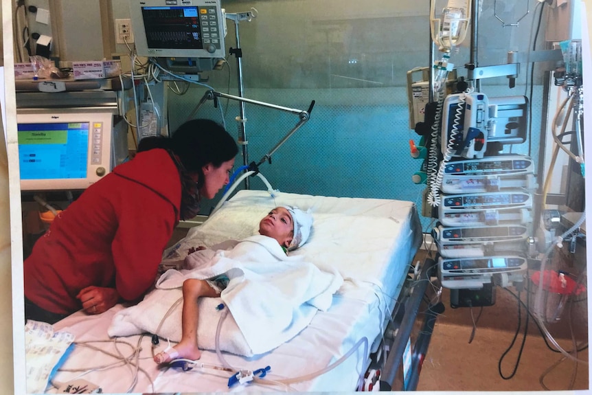 Lorenzo Zaratta lies on a hospital bed.