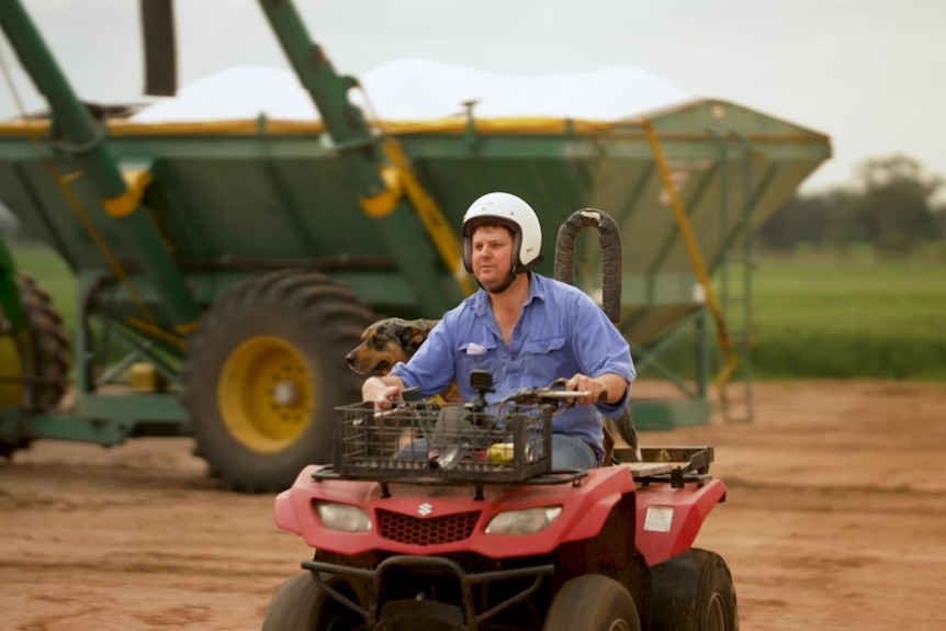 Photo of a man driving a quad bike.