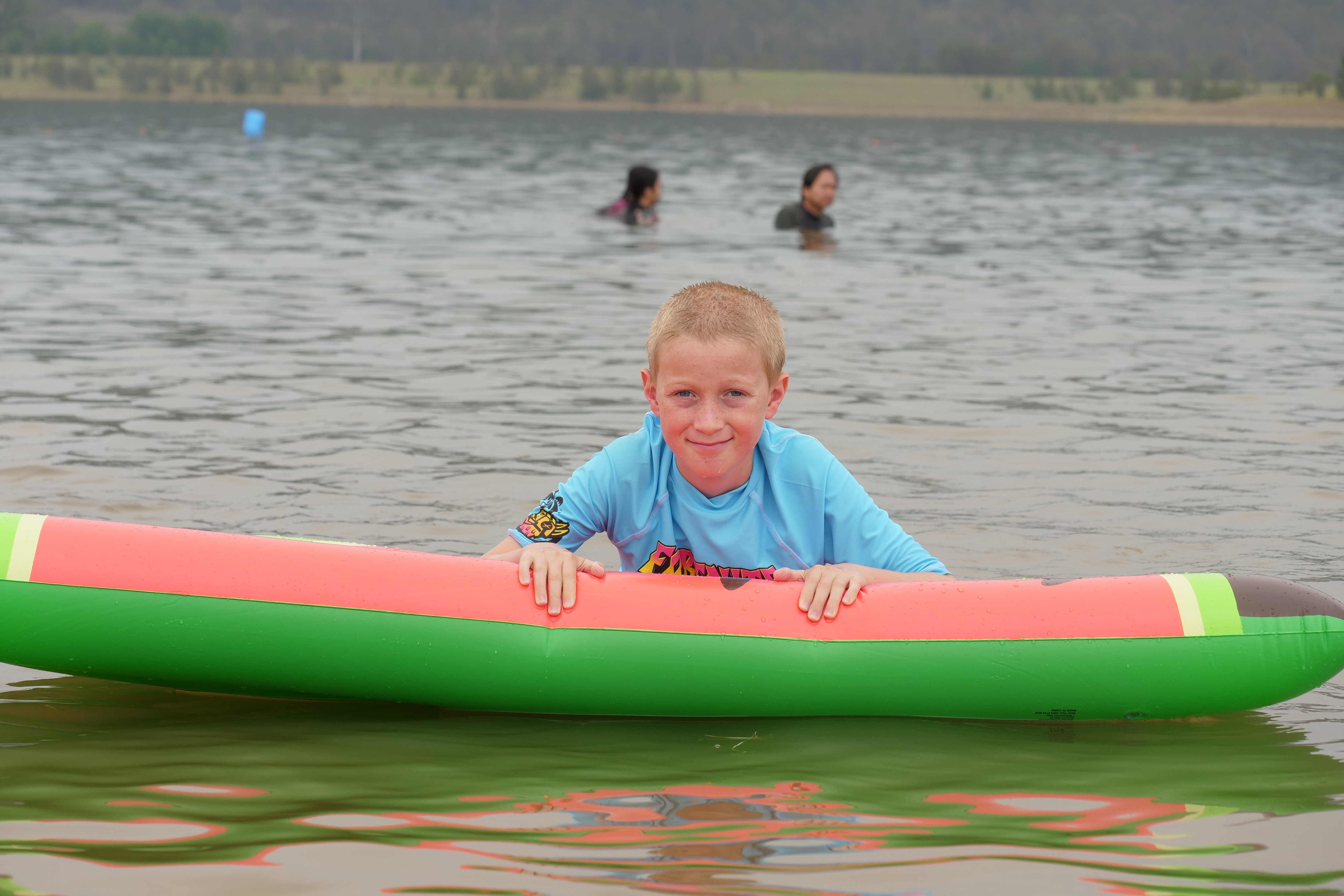A child on a watermelon floatie.