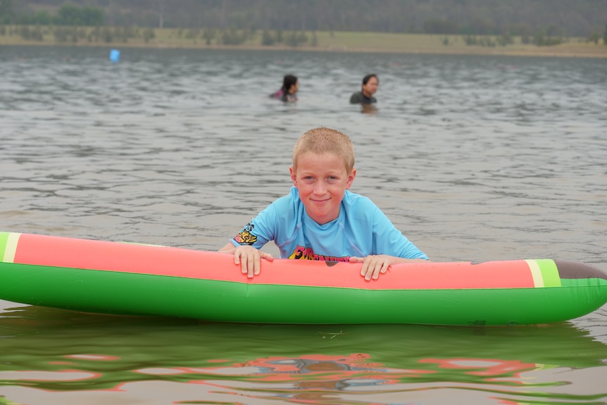 A child on a watermelon floatie.