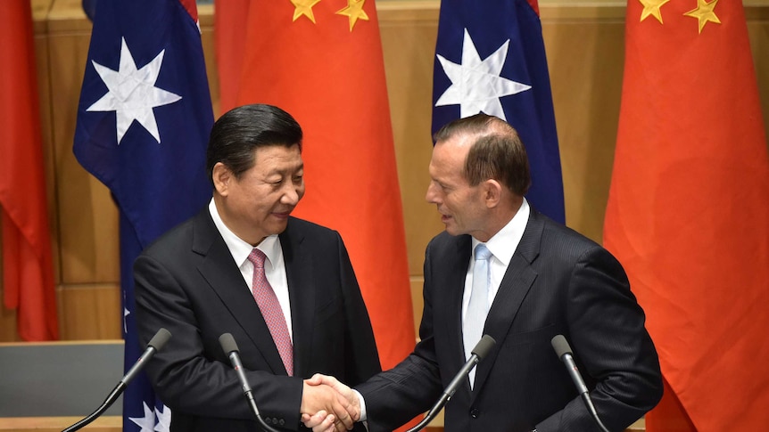 China's president Xi Jinping shakes hands with Tony Abbott following the signing of the FTA.