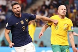 France's Olivier Giroud runs away from Socceroos' Aaron Mooy after a goal in their Qatar World Cup game.