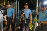 Police secure a crime scene where a drug runner was killed in Marikina City, Philippines
