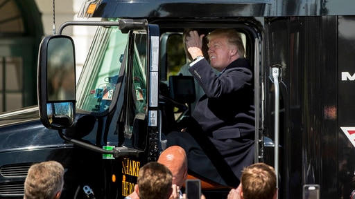 Donald Trump honks the horn of an 18-wheeler truck while meeting truckers and CEOs regarding healthcare on the White House lawn.