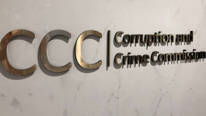 A large metal sign on a wall that says: 'CCC | Corruption and Crime Commission.