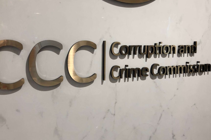 A large metal sign on a wall that says: 'CCC | Corruption and Crime Commission.