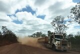 Truck stirs up red dust as it travels along Peninsula Developmental Road in far north Queensland.