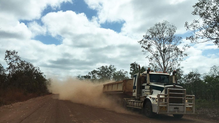 Truck stirs up red dust as it travels along Peninsula Developmental Road in far north Queensland.