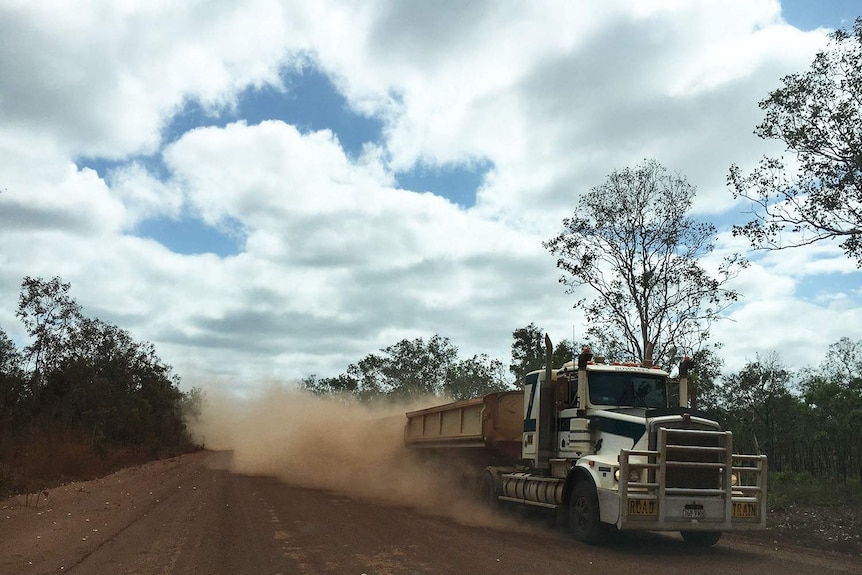 Truck stirs up red dust as it travels along Peninsula Developmental Road in far north Queensland.
