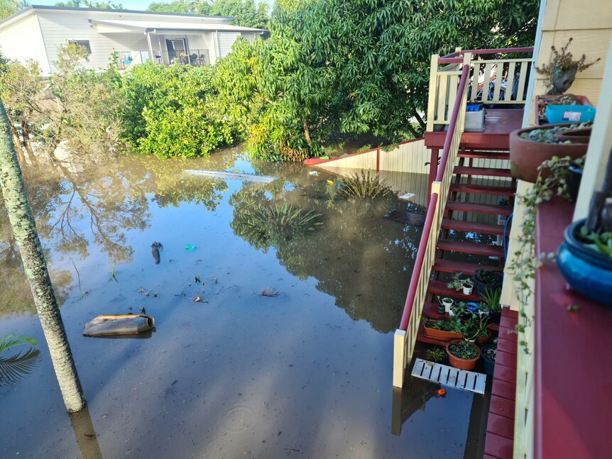 Flood water inundates an entire backyard. 