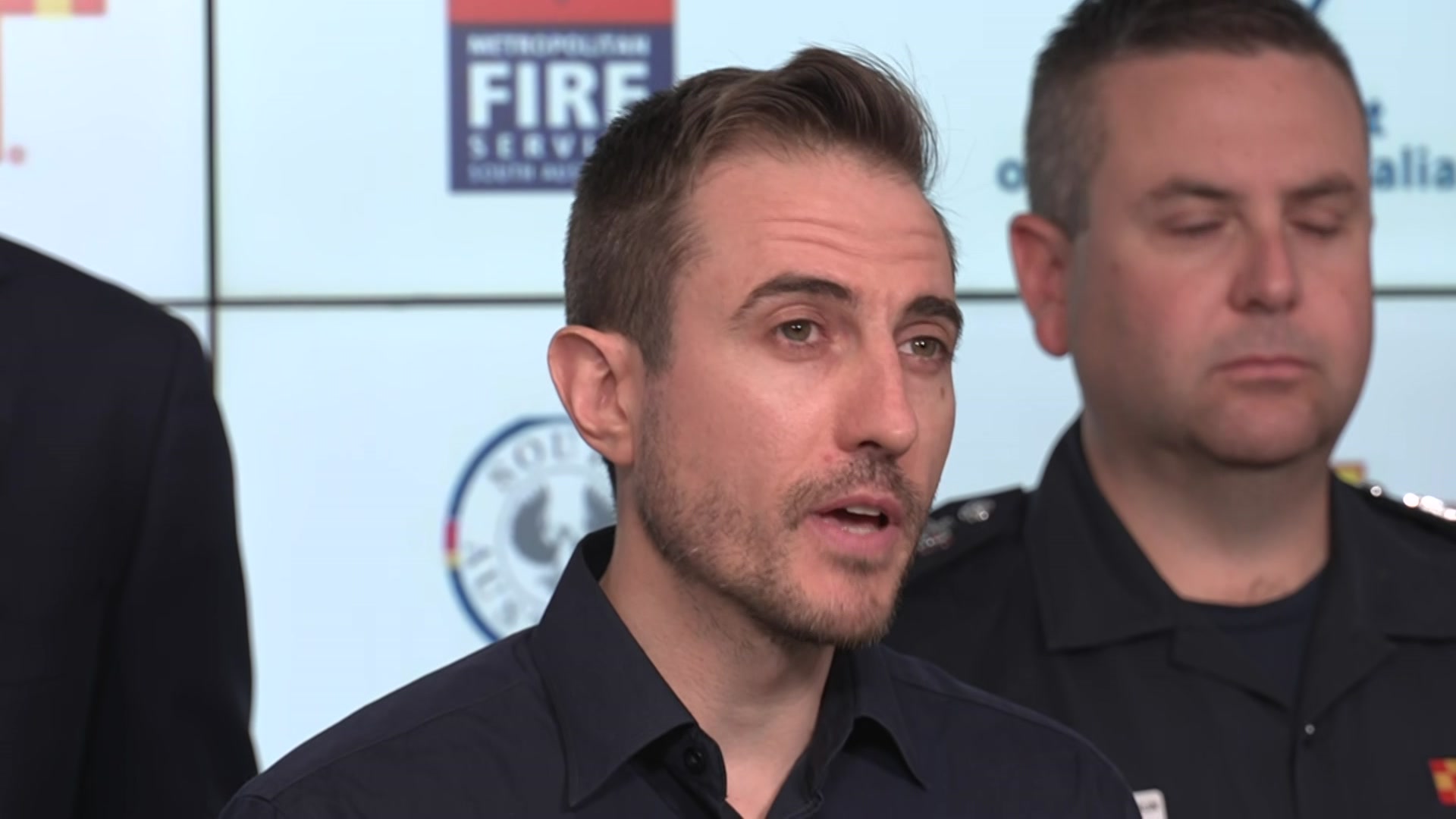 Jonathan Fischer at a media conference in front of CFS chief and SA premier