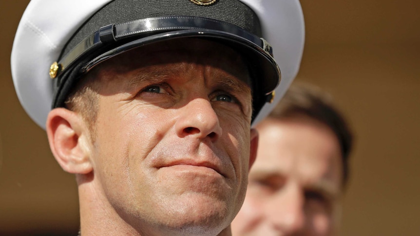 Side profile shot of  Navy Special Operations Chief Edward Gallagher wearing a white navy hat