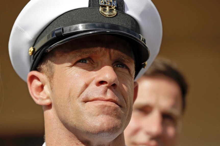 Side profile shot of  Navy Special Operations Chief Edward Gallagher wearing a white navy hat