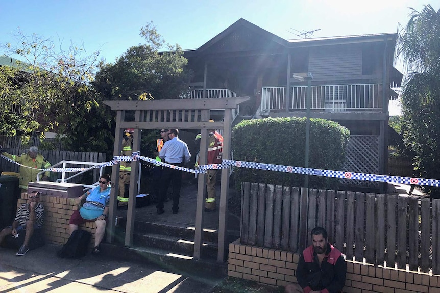 Police and residents outside a unit block where fire claimed a man's life