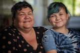 A woman with a little girl sitting on her lap