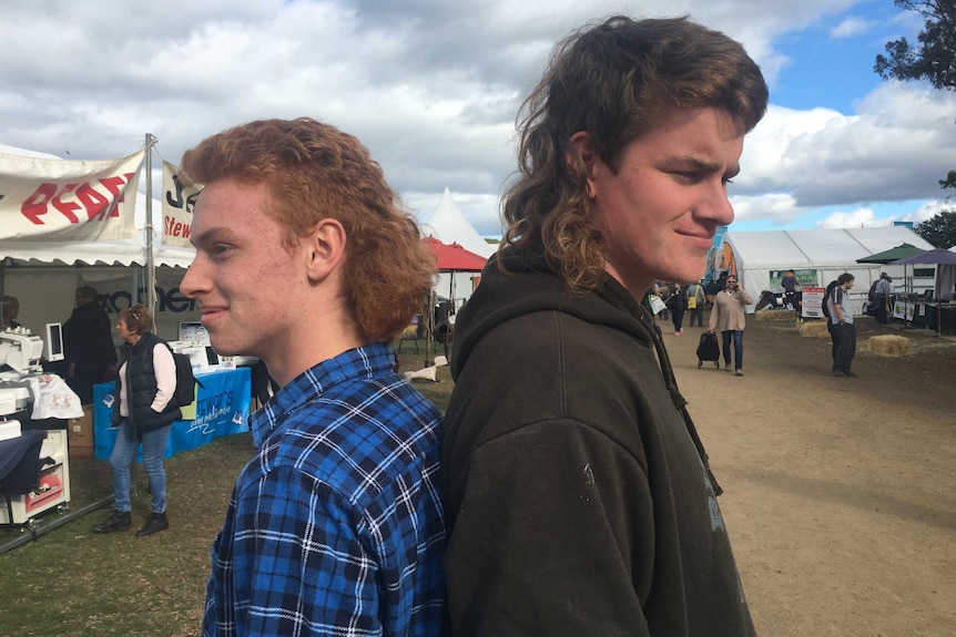 Two men wearing mullets.