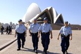 Police officers patrol in front of the Sydney Opera House, one of the venues of the APEC summit. (File photo)