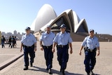 Police officers patrol in front of the Sydney Opera House, one of the venues of the APEC summit. (File photo)