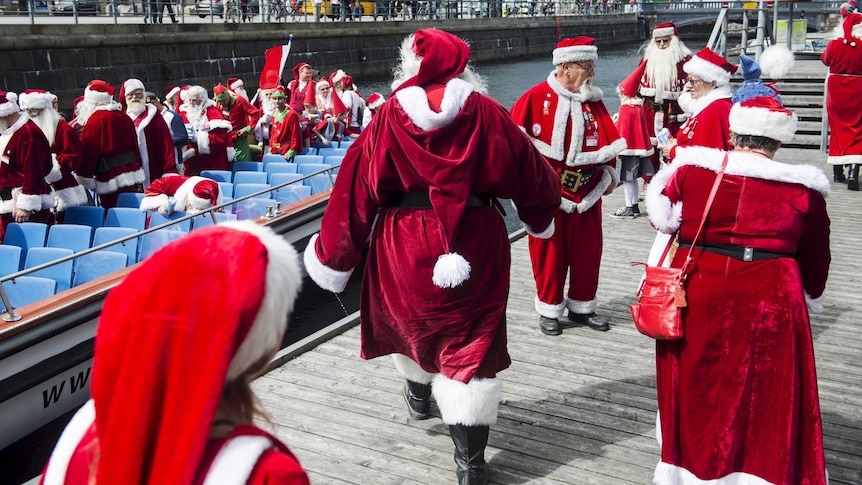 Participants take a boat tour during the World Congress of Santas in Copenhagen, Denmark