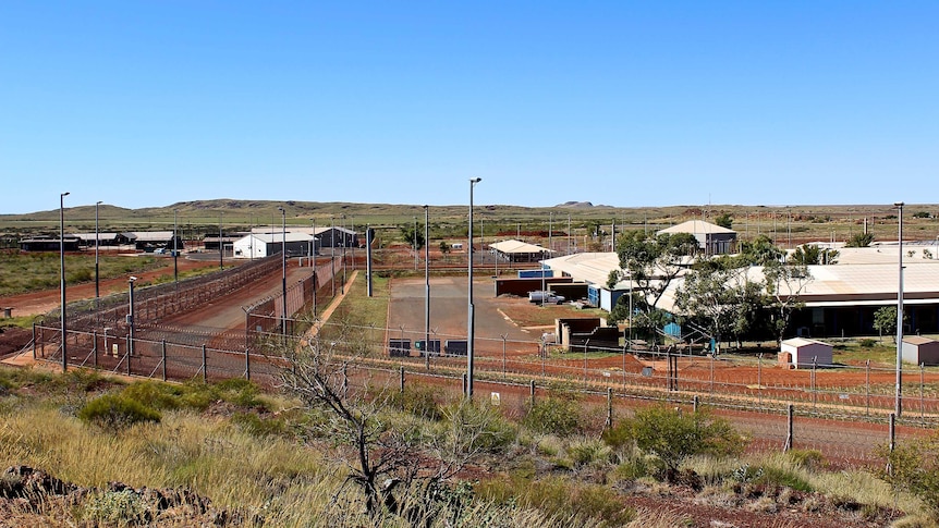 A wide shot looking from a hill into Roebourne prison