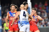 Gary Ablett (centre) of the Cats is seen scuffling with Anthony Miles (right) of Gold Coast.